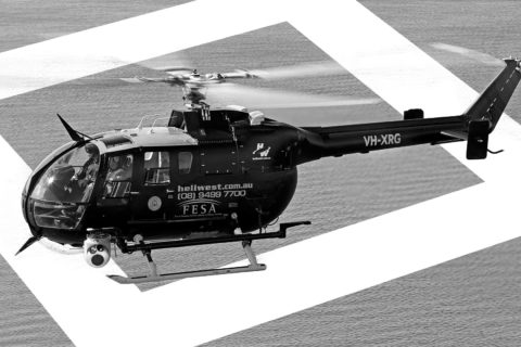 Bo 105 Helicopter registered to Heliwest flying over ocean