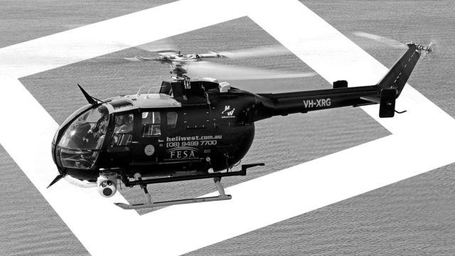 Bo 105 Helicopter registered to Heliwest flying over ocean