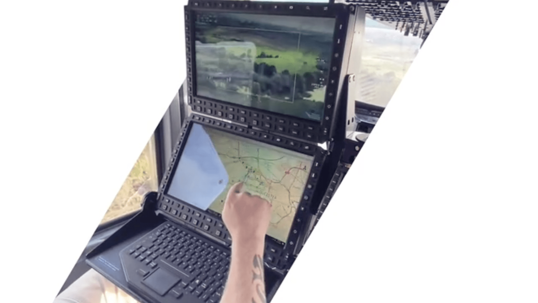 Picture of operator using touchscreen with EO/IR feed