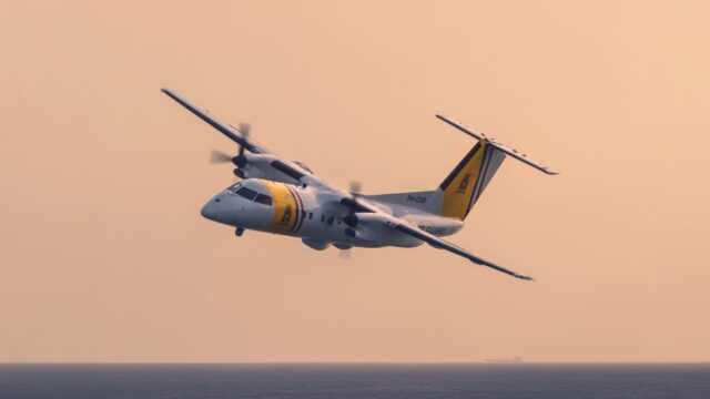 DCCG Dash 8-100 banks low with sunset in background